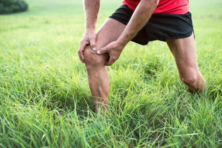 Man holding his knee in pain
